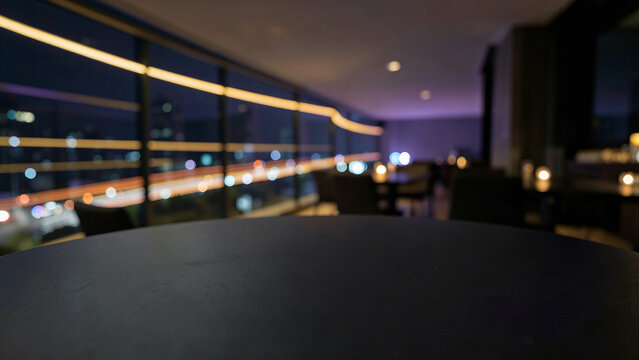 Matte Black Slate Table Surface on Modern Penthouse Balcony Bar with Glass Railings Luxury City Boke