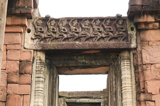 Amazing ancient stone lintel carving depicting traditional dancers on a lintel at Phimai castle, Nakhon Ratchasima, Thailand