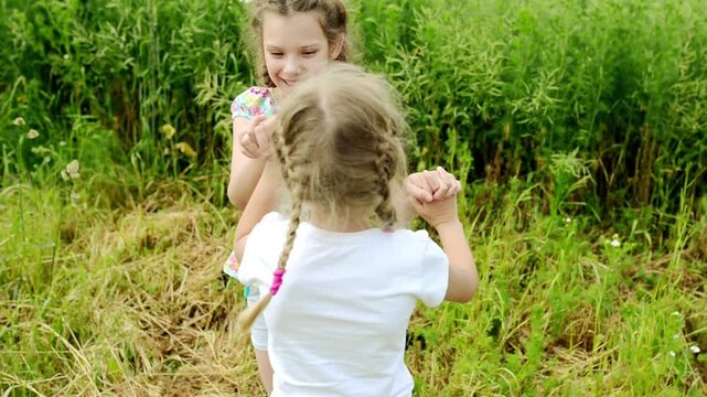 Two cheerful beautiful little sisters playing