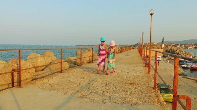 Two little girls walk near Tsarevo in Bulgaria