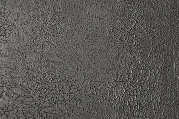 Fototapeta premium Abstract black cracked paint or leather material texture