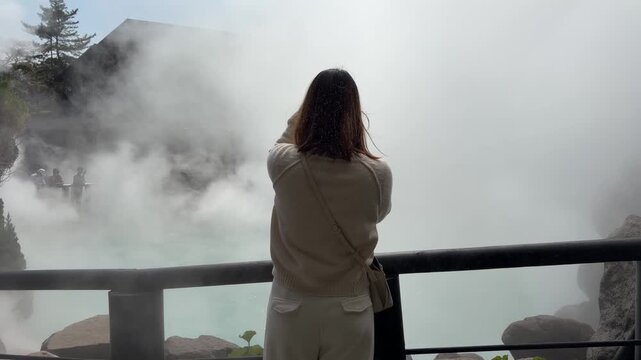 Young Female Tourist Looking at Sea Hell Hot Spring Smoke in Japan