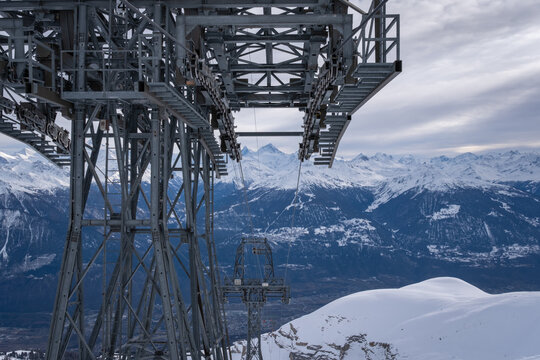 Panoramic view from Funitel Violettes-Plaine Morte with aerial lift pylon in Crans-Montana, Switzerland over Rhone Valley towards Matterhorn mountain against cloudy sky