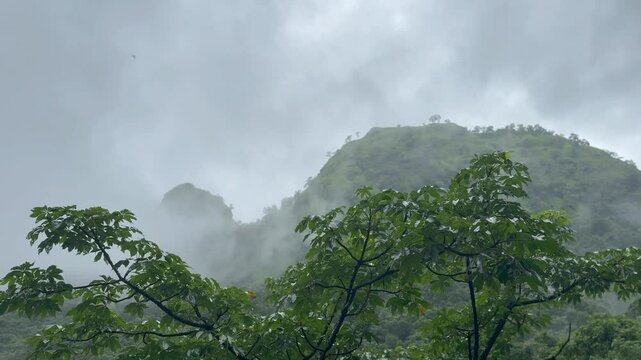 Misty clouds over the mountains of western ghats of Indian during monsoon season, Raigad, Maharashtra.