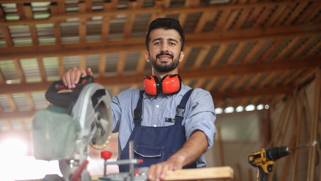 Woodworker smiles confidently with circular saw