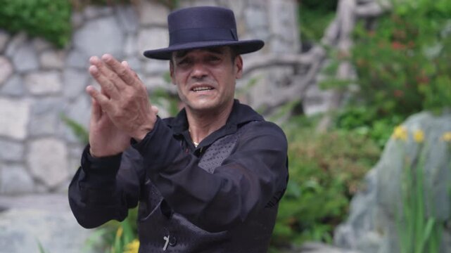 The flamenco dancer is a man. Portrait of a Spaniard. Arm Movements Palmas