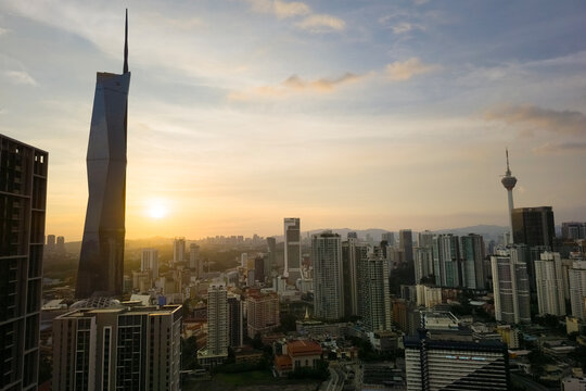 Kuala Lumpur, Malaysia - May 28, 2026: View of the city skyline during a golden sunset, showcasing the massive Merdeka 118 skyscraper on the left and the KL Tower on the right during evening sky.