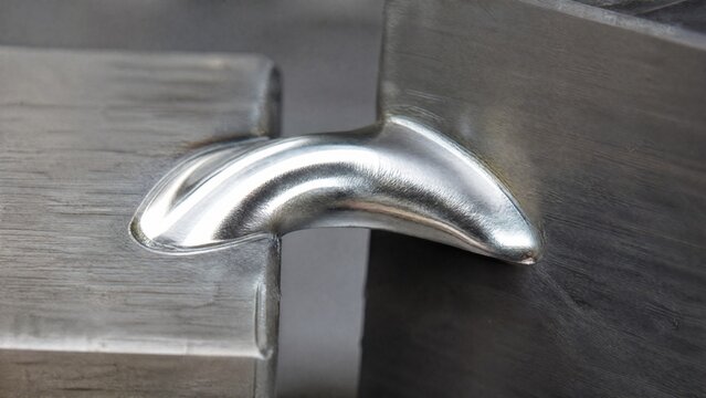 A smooth, silvery arc of solidified braze material on a metal joint.