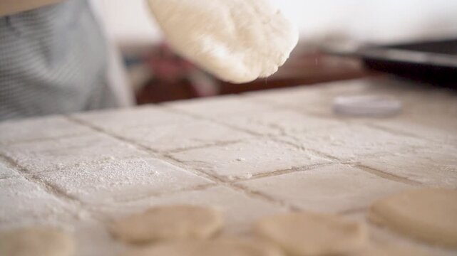 young african woman hands for baking bread or pastry with rolling pin on table in kitchen for recipe concept, homemade food preparation and livelihood and employment in africa