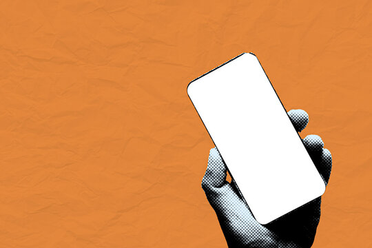 Pop art halftone hand holding blank white smartphone screen mockup on crumpled orange paper background. Retro mixed media digital communication and creative mobile app advertising template concept.