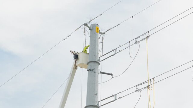 Electrical power linemen in bucket lift