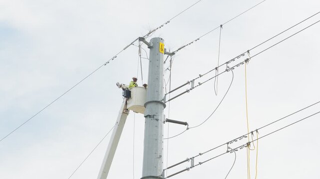 Electrical power linemen in bucket lift