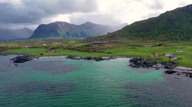 Discover Lofoten Island in Norway, featuring beautiful landscapes, camping site on Hov Beach, and dramatic mountains near the shore. Experience the natural beauty of this remarkable area.