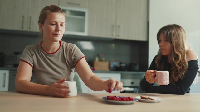 Mother and daughter having a difficult conversation in the kitchen