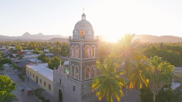 Experience the sunset at Loreto Mission church in Baja California Sur. See the oasis and desert landscape from above.