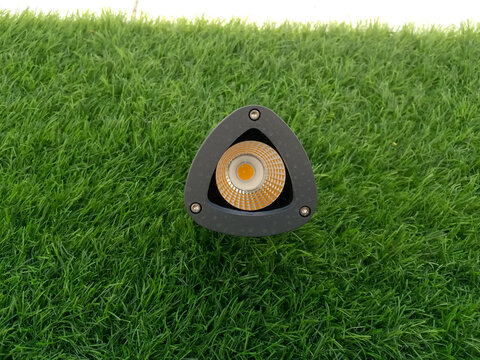 Modern Outdoor LED Garden Spike Light on Green Grass Background freshly cut lawn of bright green artificial turf grass,