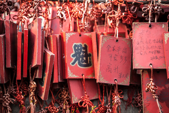 Red wooden Buddhist prayer tablets hanging in a temple, Pingyao, Shanxi, China