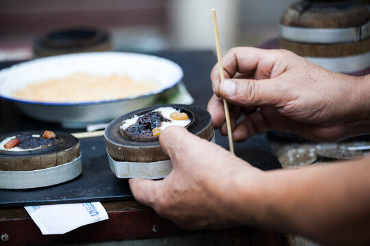 Hands shaping a traditional rice cake at Xi'an market, Xi'an, Shaanxi, China