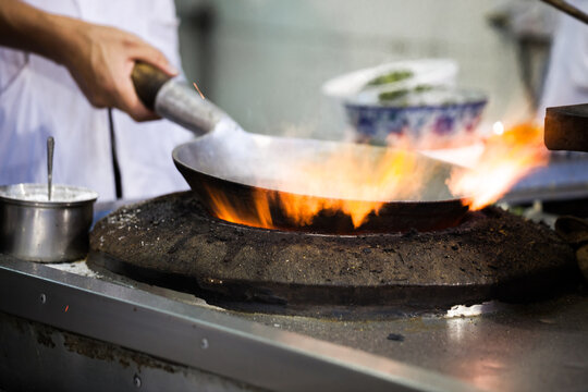 Man cooking at a street food stall, Xi'an, Shaanxi, China