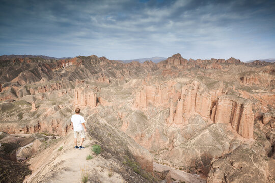 Adult visitor at the edge of bingou danxia canyon, Zhangye, Gansu, China