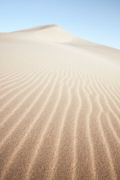 Sand dune ridges at sunrise in the Mingsha desert, Dunhuang, Gansu, China