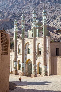 Mosque facade and minaret in the streets of Toyuq, Turpan, Xinjiang, China