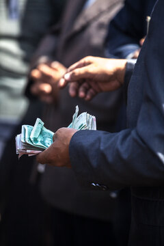 Merchant counting banknotes at Kashgar livestock market, Kashgar, Xinjiang, China