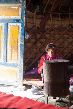 Young kyrgyz girl inside her family yurt, Karakul, Xinjiang, China