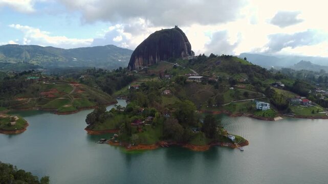  El Pe&ntilde;&oacute;n de Guatap&eacute; Rock Wide Aerial Overview from Lake on Cloudy Late Afternoon
