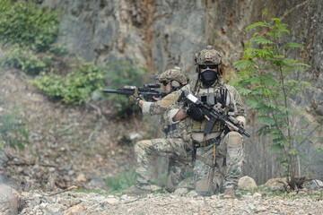 Naklejka premium US Special forces soldiers engaged in combat operation, tactical military team in action