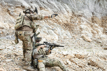Naklejka premium US Special forces soldiers engaged in combat operation, tactical military team in action