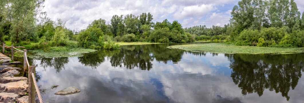 Pedestrian crossing of the Molenplas protected area near Stevensweert, part of the Maas valley river park on the Netherlands Belgium border, designed for water storage and nature restoration