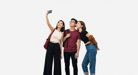 Obraz premium Happy Group of Young Asian Friends Taking a Selfie Together on White Background