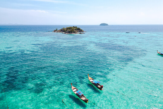 Aerial Drone View of Koh Lipe Island Beach with Turquoise Water and Longtail Boats, Thailand