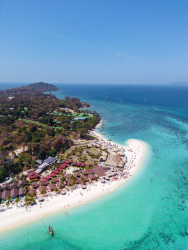 Aerial Drone View of Koh Lipe Island, vertical photo with Turquoise Water and Longtail Boat and hotel , Thailand