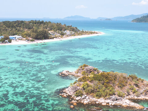 Aerial Drone View of Koh Lipe Island Beach with Turquoise Water and Longtail Boats, Thailand