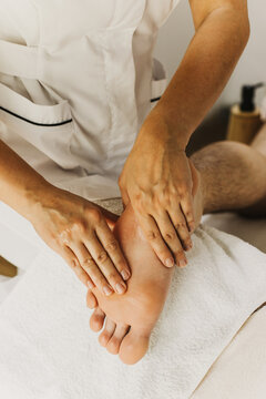 Close up of leg massage therapy session. Female massage therapist's hands.