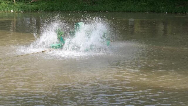 Electric Water Aerator Spinning In Brown Pond Splashing Water