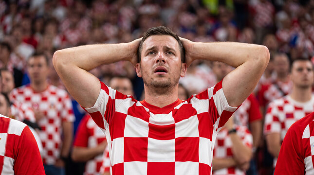 Stressed Croatian male soccer fan reacting to missed chance