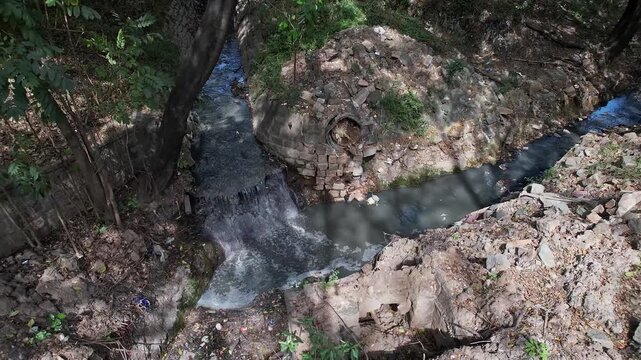 View shows a Overflowing drain Surpassing Debris Filled Area with Stagnant Water
