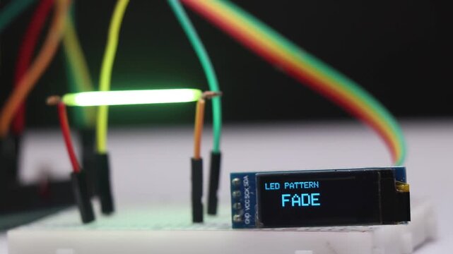 Filament bulbs showing the patterns of fading, pulsing and strobing in sync with OLED pattern display on breadboard