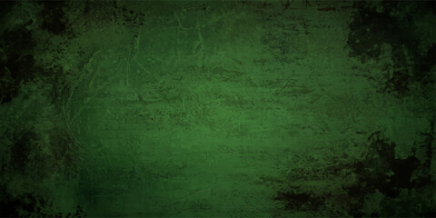 Fototapeta premium A dark and aged grunge green background features a rough, textured concrete wall surface with a vintage, dirty paint design