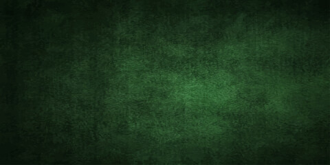 A dark green grunge wall texture with an aged rough pattern and central light copy space for vintage retro design © Kazim