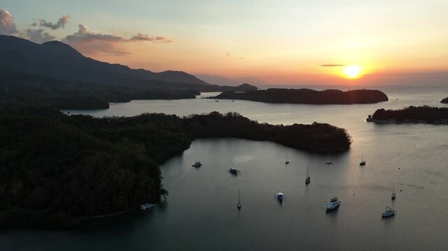 Drone view of Puerto Galera coves and anchored boats at sunset