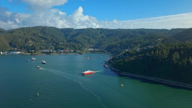 Aerial Panning landscape of Corral Bay with Cargo Ships in Valdivia Chile in Forested Natural environment