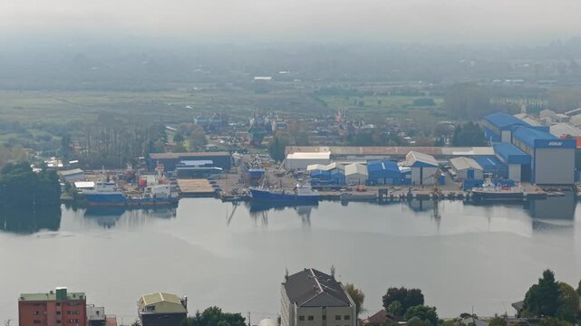 Telephoto aerial view of the giant ship repair yards and cargo ship dismantling facilities in Valdivia, Chile