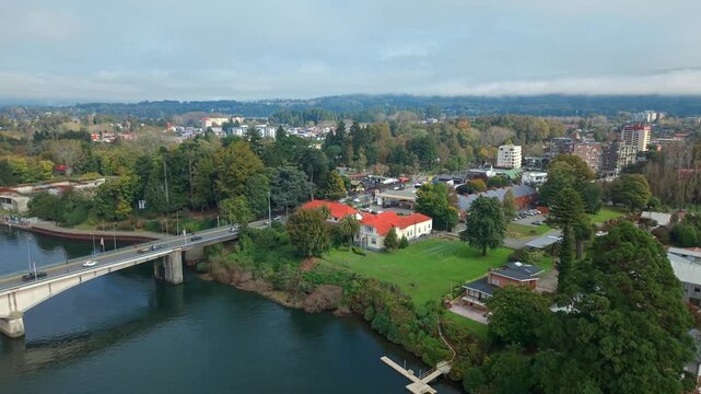 Aerial view dolly in Teja Island on the banks of the Calle Calle River in Valdivia, Chile, on a sunny day