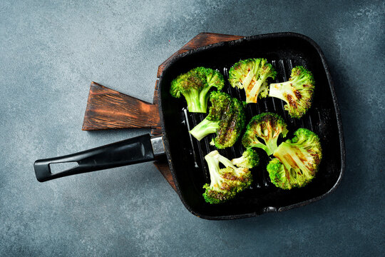 Organic green broccoli fried in a pan. Grill pan. Cooking healthy diet food.