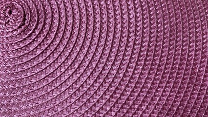 Fototapeta premium A purple woven texture with a detailed and symmetrical spiral pattern. Featuring a tightly woven, decorative grain, it's perfect for use as a background or design element in crafts.