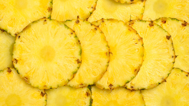 Pineapple background. Yellow juicy slices of ripe pineapple. Close-up, macro photo.